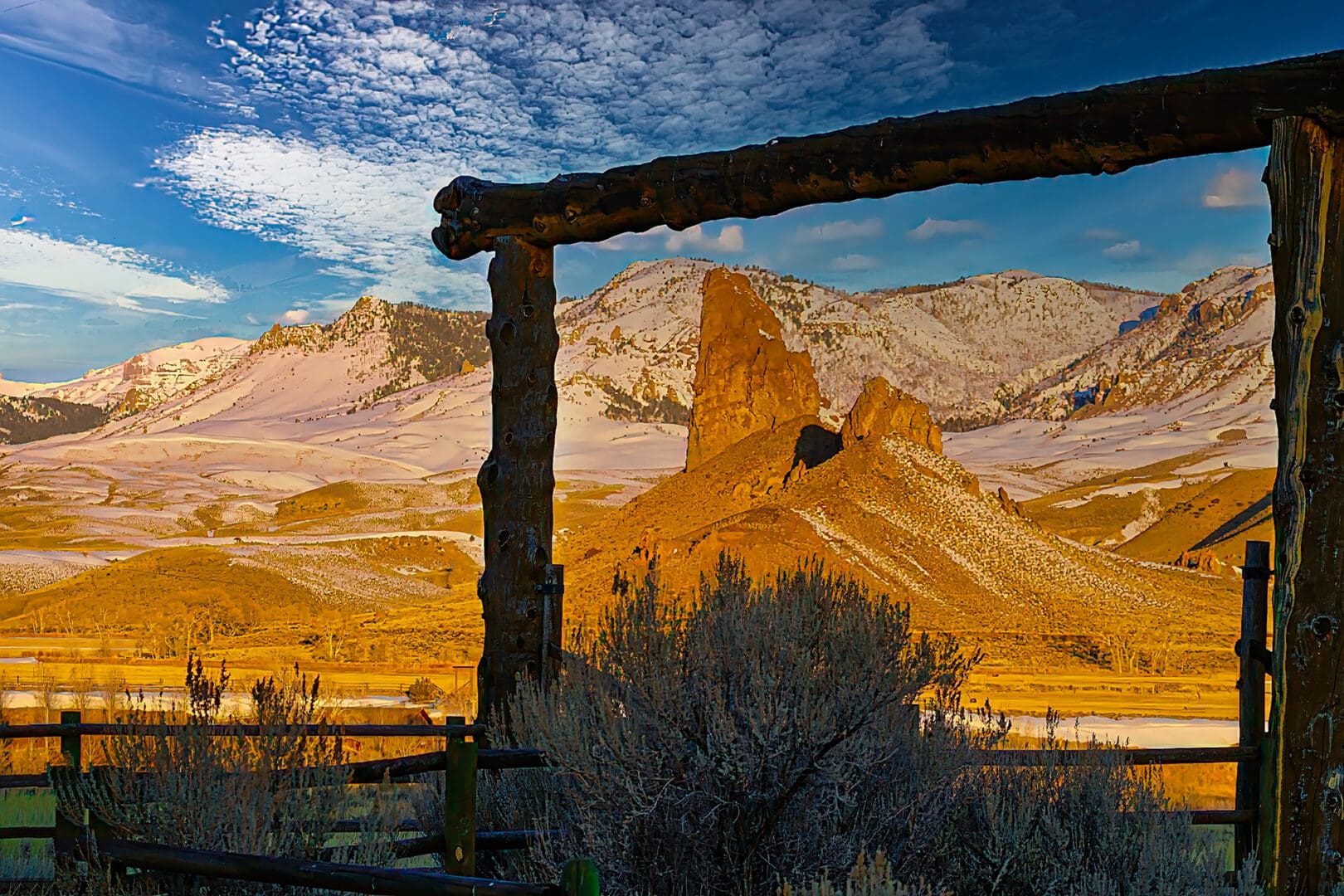 A wooden fence in the middle of a field.