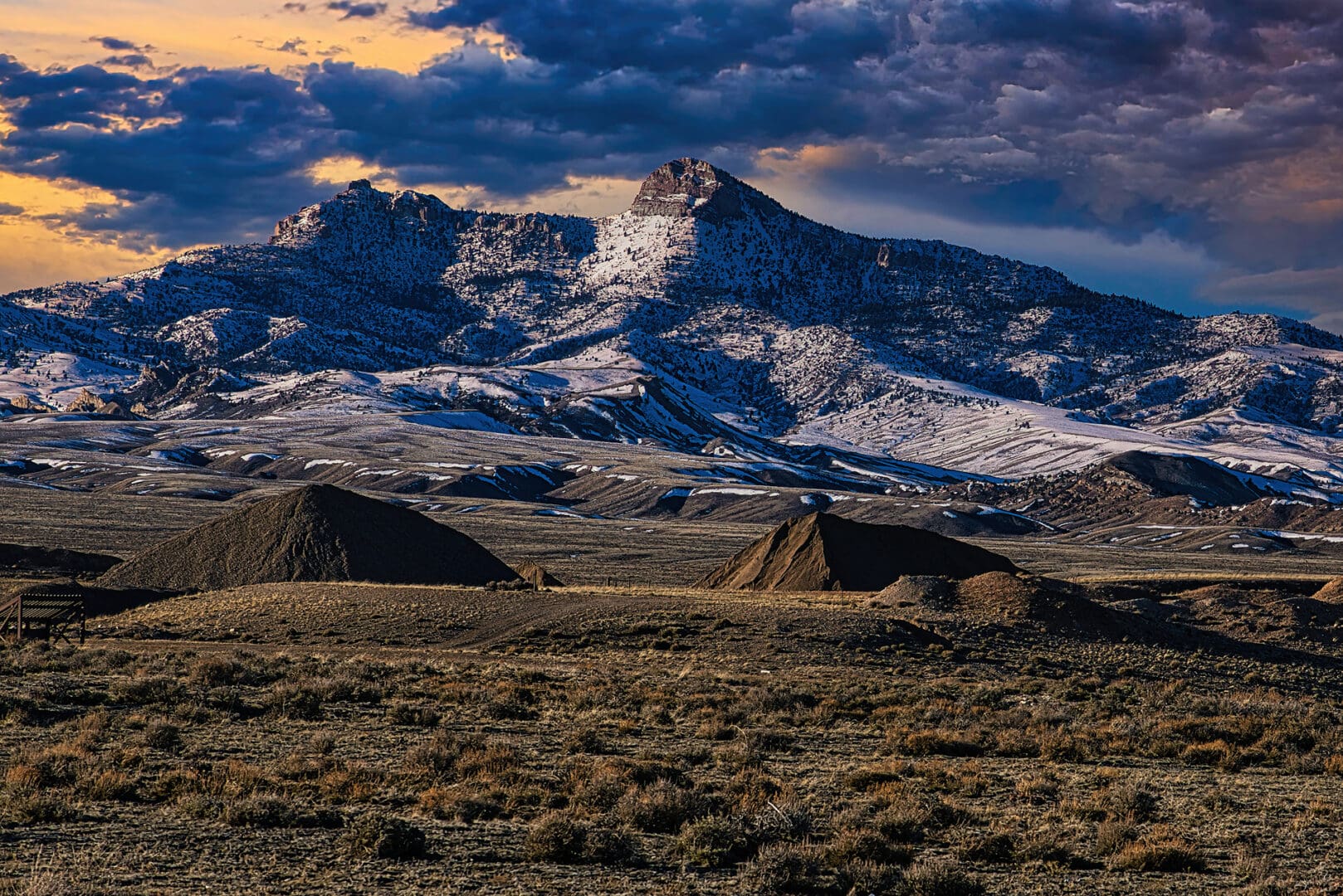 A mountain range with a cloudy sky.