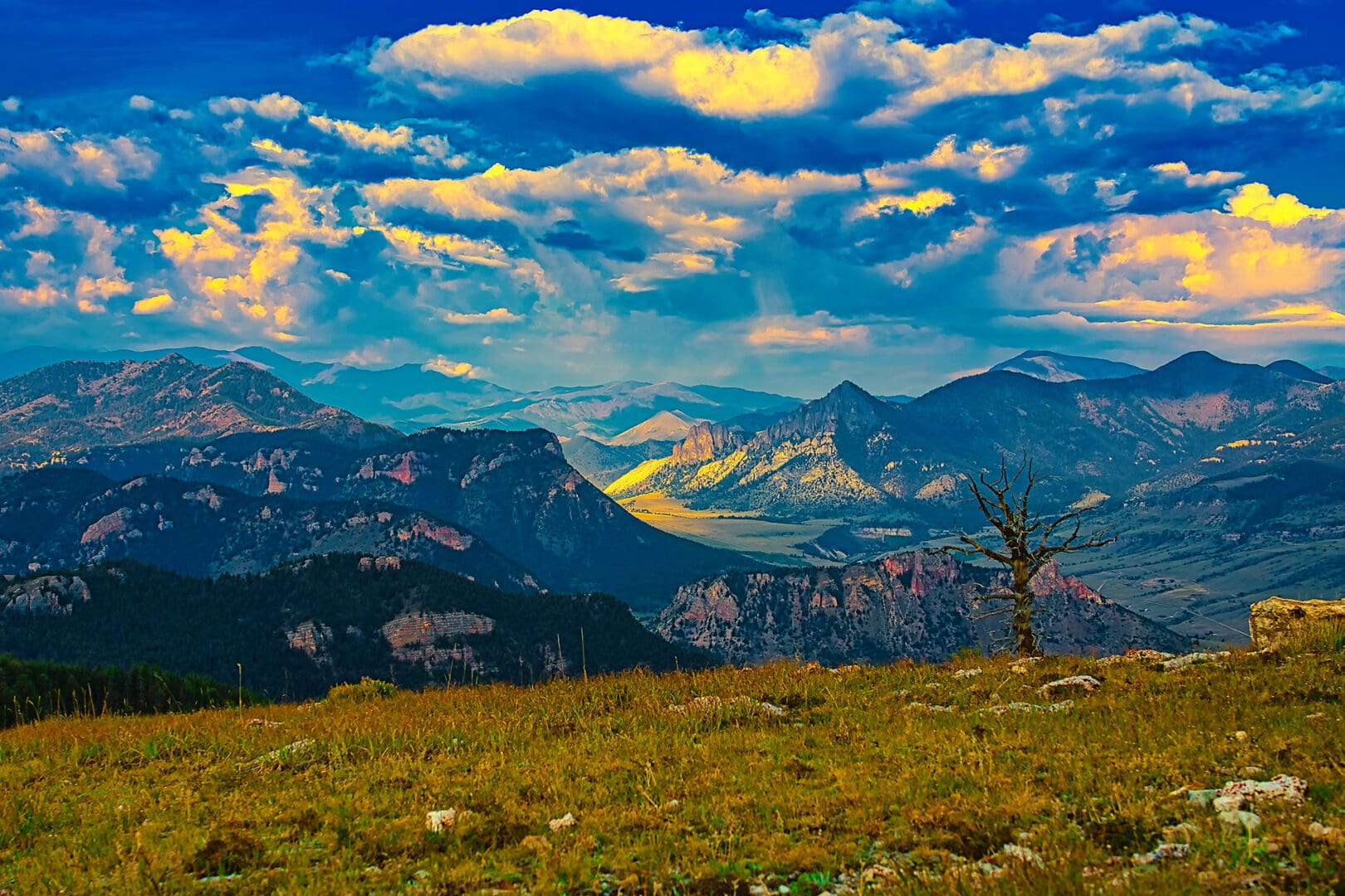 A cloudy sky with mountains in the background.