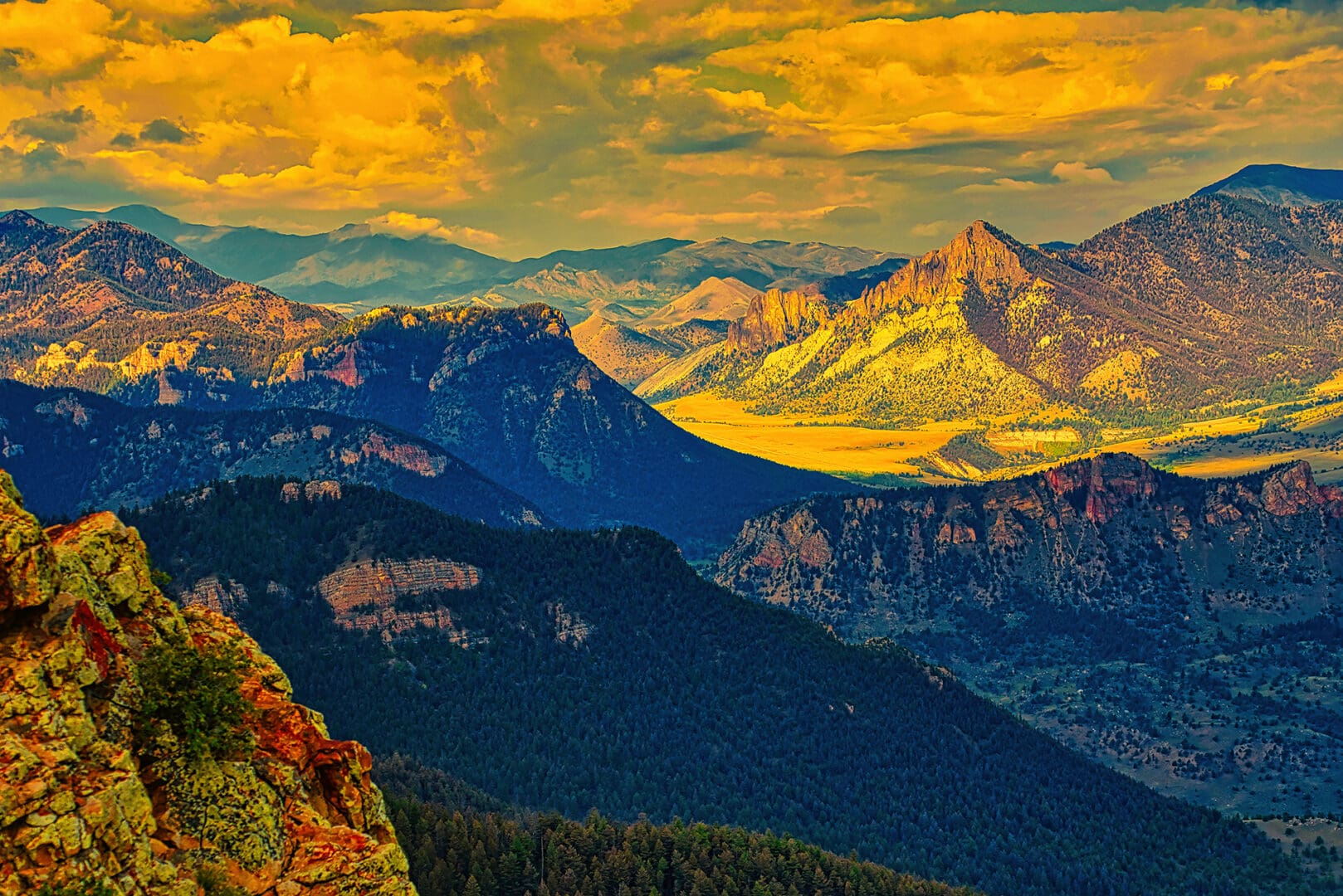 A view of the mountains from the top of a cliff.