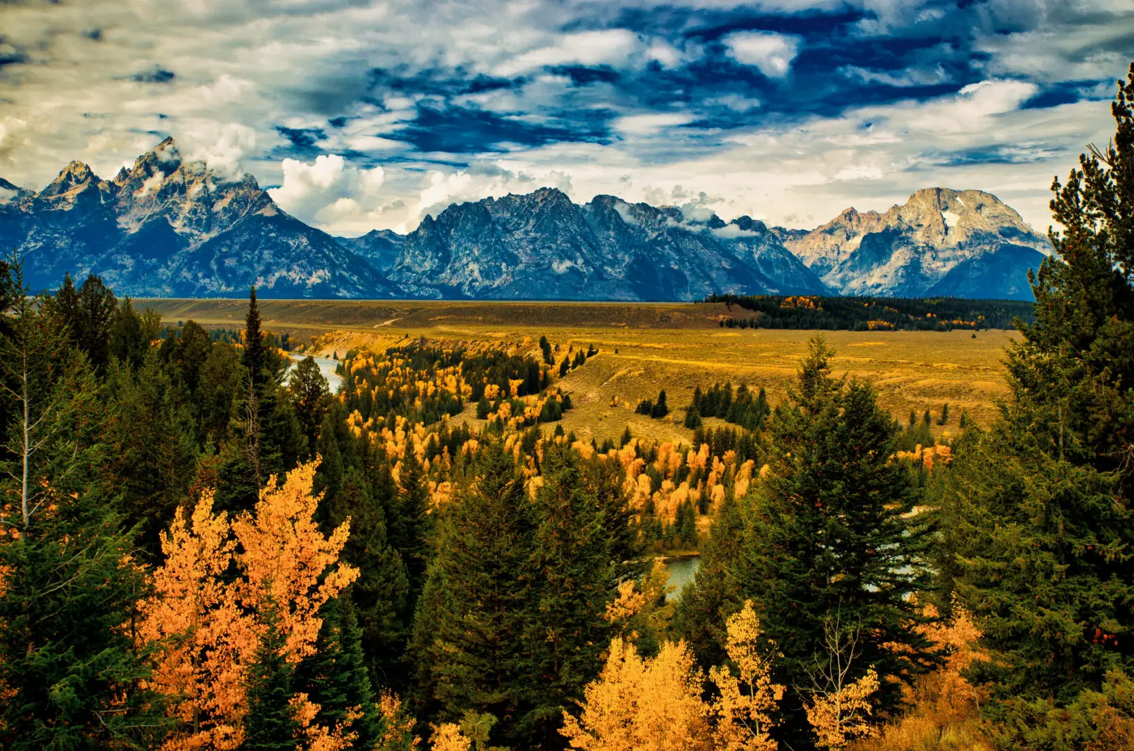 A view of the grand teton mountains in autumn.