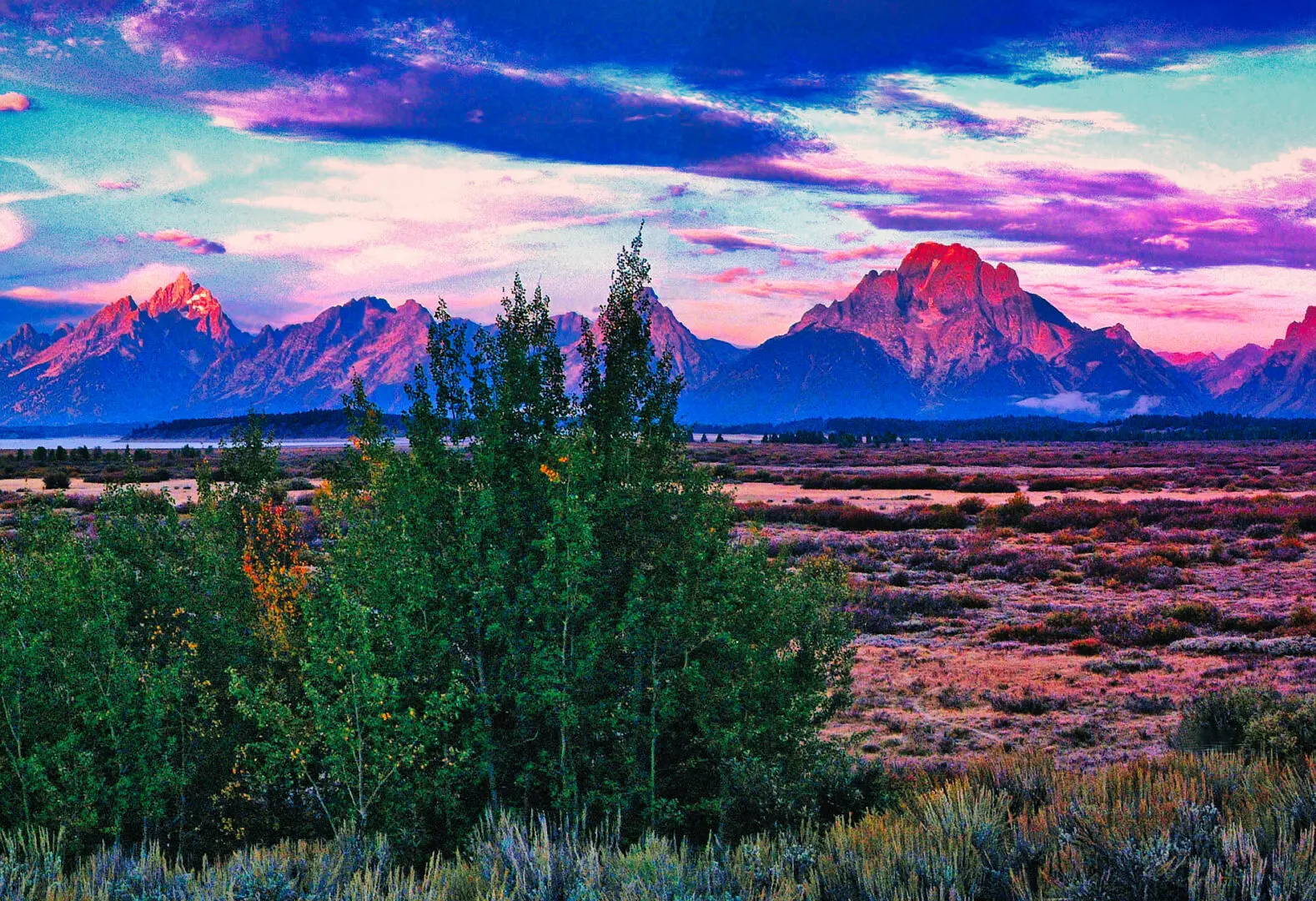 The grand teton mountain range at sunset.