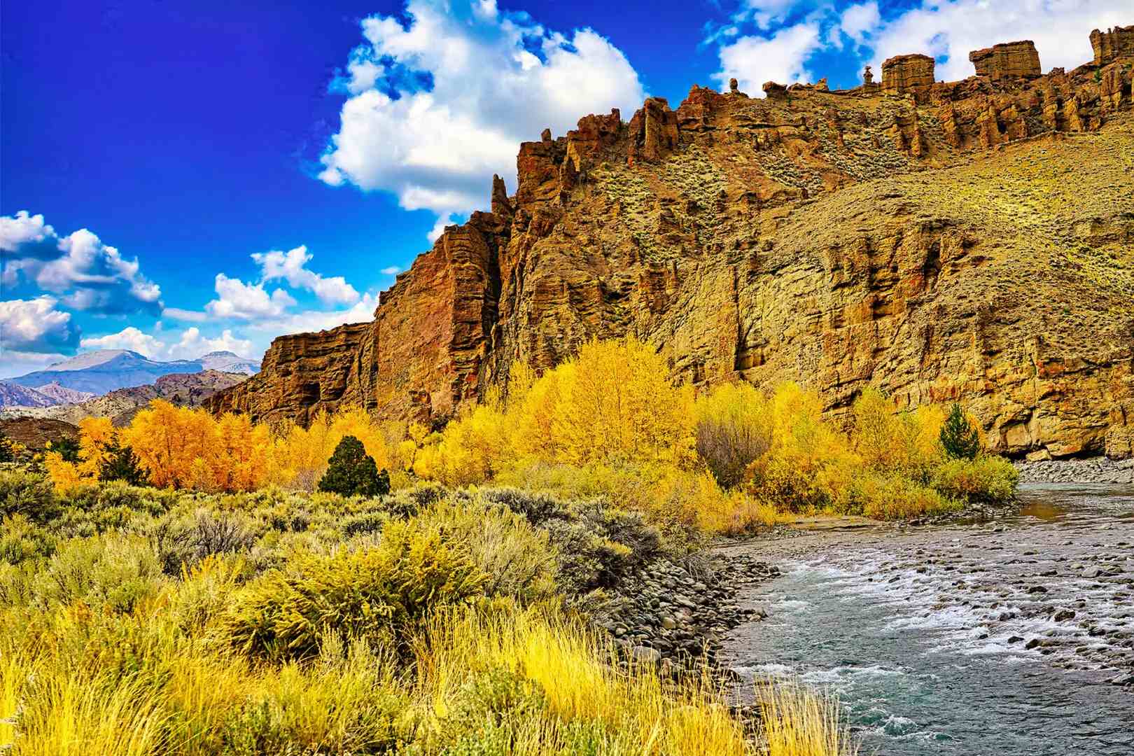 A river flows through a canyon in the fall.